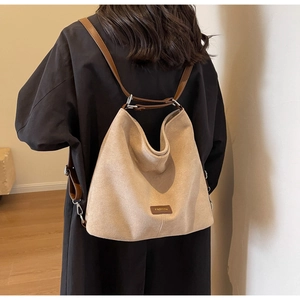 Close-up of khaki PU leather bag with adjustable brown strap and silver metal buckle detail
