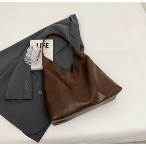 Top view of brown faux leather tote bag with soft texture and minimalist geometric design