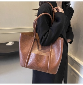 Detailed view of brown PU leather tote bag with vintage texture and large capacity