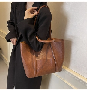 Brown faux leather tote bag with double handles and long shoulder straps for versatile use