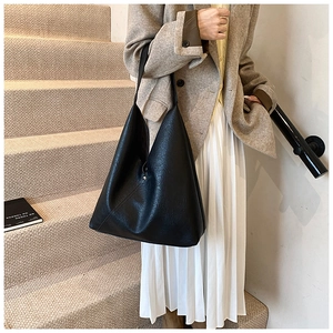 Detail showing high-quality black litchi pattern PU leather on a large tote bag