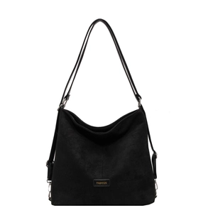 Minimalist black matte faux leather shoulder bag with fashion label on white background
