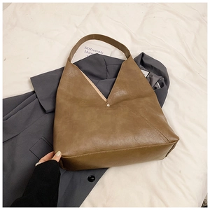 Minimalist vintage dark brown PU leather tote bag with V-cut design on grey fabric