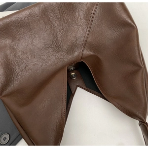 Detail of the brown vintage faux leather tote bag showing the magnetic snap closure