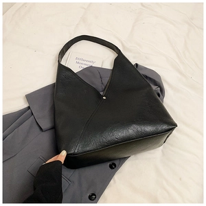 Minimalist black PU leather shoulder bag with asymmetrical fold design and gold stud