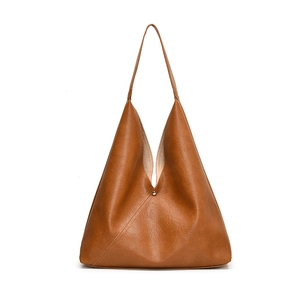 Brown faux leather tote bag with V-shaped minimalist design and magnetic clasp closure