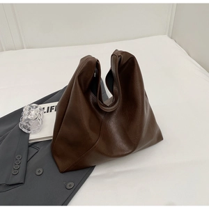 Detail of soft brown faux leather tote bag showing spacious interior and natural texture
