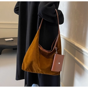 Detail of deep brown suede tote bag featuring high-quality texture and a small coin purse