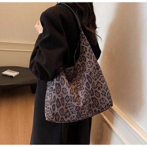 Detailed shoulder view of a large leopard print tote bag with soft suede-like texture