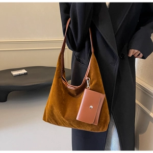 Detail of caramel brown suede hobo tote bag with a small matching envelope pouch