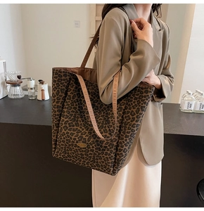 Detail of the leopard print velvet tote bag with a handmade tag and shoulder strap