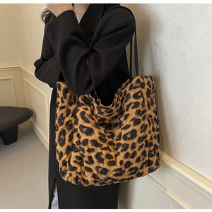 Detail showing the leopard print pattern and quilted texture of the fabric tote bag