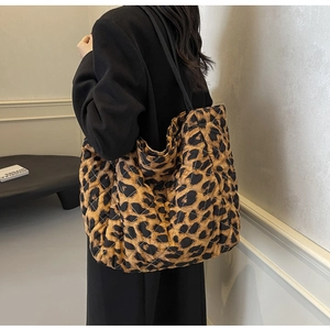 Detail of trendy leopard print quilted tote bag featuring spacious double shoulder straps