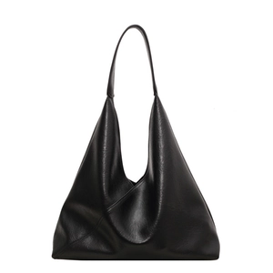 Minimalist black PU leather hobo bag with asymmetrical fold and oversized silhouette