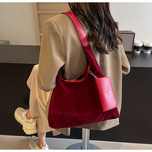 Detail view of burgundy velvet shoulder bag with detachable matching coin purse accessory