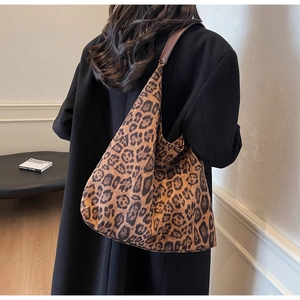 Detail of trendy leopard print tote bag with durable canvas and leather handle stitching
