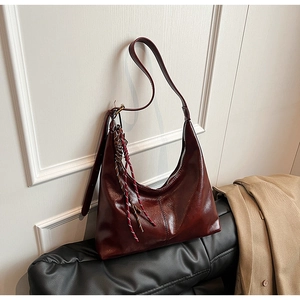 Deep reddish-brown PU leather shoulder bag with glossy texture and rainbow woven charm
