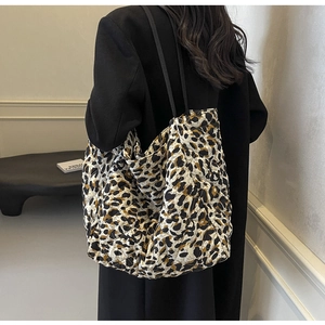 Detail of a large leopard print quilted tote bag showing texture and spacious design