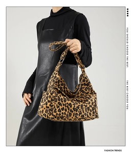 Detail of leopard print tote bag showing side pockets and textured canvas material