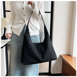 Detail view of the black matte leather tote bag with soft hobo style and long shoulder straps