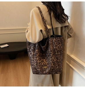 Leopard print tote bag shown on a model with a beige trench coat for a stylish fall look