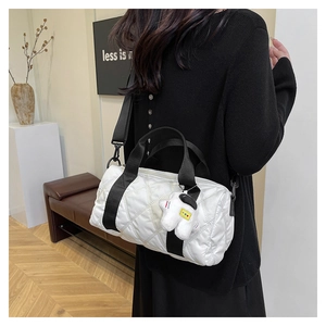Quilted nylon Boston bag with black straps and astronaut pendant shown on model