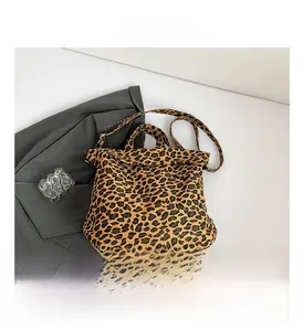 Detailed overhead view of a leopard print canvas tote bag with dual straps and chic styling