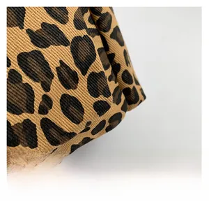 Close-up detail of high-quality leopard print canvas fabric for stylish shoulder bags