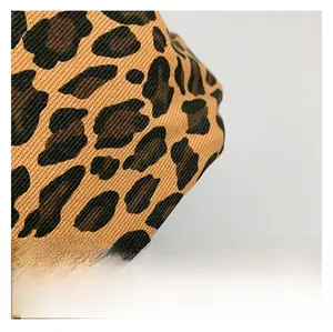 Close-up of premium leopard print canvas fabric showing detailed texture and patterns
