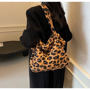 Detail view of the quilted leopard print pattern on a large capacity tote shoulder bag