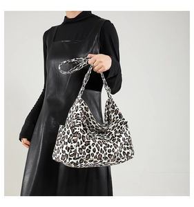 Close-up of leopard print canvas shoulder bag on model for casual retro style