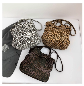 Detailed comparison of three leopard print canvas tote bags in various color patterns