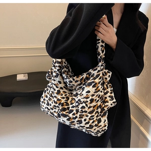 Detail of large leopard print quilted shoulder bag with fluffy texture and autumn design