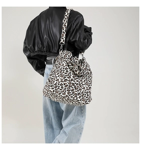 Detail of the large canvas tote bag with bold leopard print and wide shoulder strap