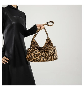 Detail shot of leopard print canvas shoulder bag highlighting texture and fabric