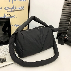 Minimalist black quilted puffer shoulder bag with stylish padded design and crossbody strap