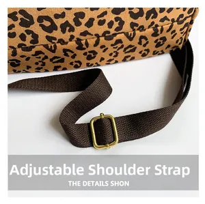 Macro shot of adjustable fabric shoulder strap with gold metal buckle on leopard print bag
