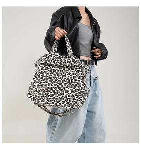 Detail of trendy leopard print canvas tote bag with adjustable shoulder straps and handles