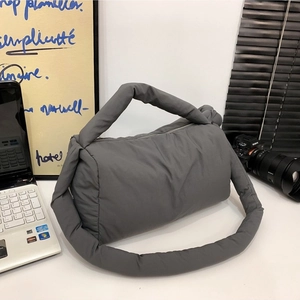 Minimalist dark grey puffer nylon shoulder bag with a cylindrical cloud-like padded design