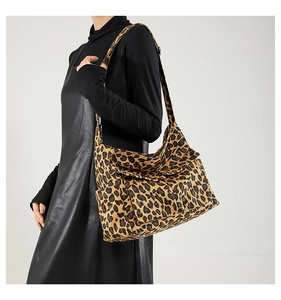Close-up of leopard print canvas tote bag featuring side pocket and adjustable strap