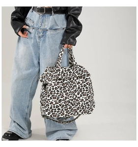 Detailed close-up of large leopard print canvas tote bag featuring premium fabric texture