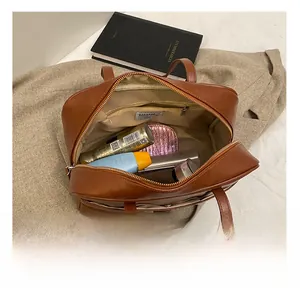 Close-up of brown PU leather Boston bag interior showing spacious storage and inner pocket