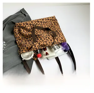 Spacious leopard print canvas tote bag interior showing daily essentials and room