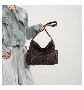 Detail view of stylish leopard print fabric shoulder bag with external side pockets