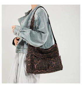 Detail view of leopard print canvas tote bag featuring double front flap pockets