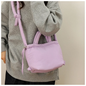 Detail view of light purple quilted cloud bag with adjustable knotted nylon strap