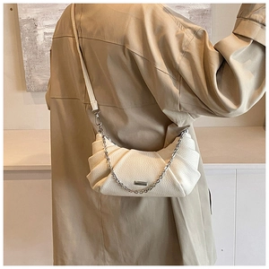 Off-white pleated dumpling bag with silver chain strap shown in a back-view fashion pose