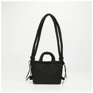 Detailed shot of black quilted nylon handbag showing water-repellent puffy cloud texture
