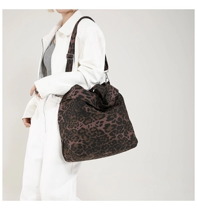 Detail of high-capacity leopard print canvas tote bag with adjustable shoulder strap