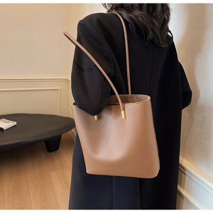 Close-up of brown litchi pattern PU leather tote bag with thin shoulder straps